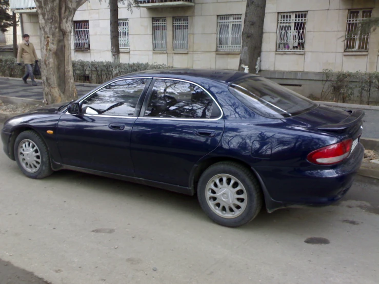 blue car parked on the side of the street