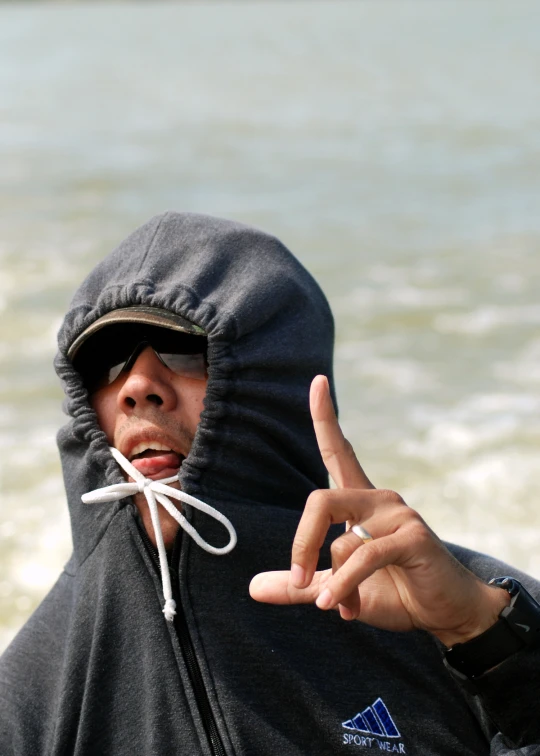 a man in a black hoodie gesturing