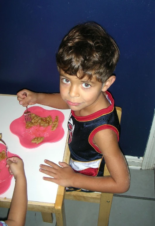 a boy is eating some peanut er cookies