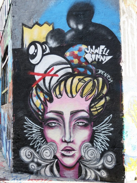 a mural of a woman is seen against a wall