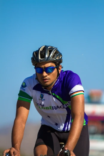 a man wearing sunglasses and a bike helmet