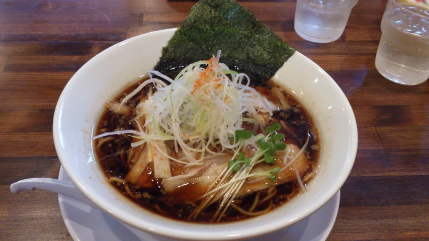 a white bowl filled with soup and some garnishes