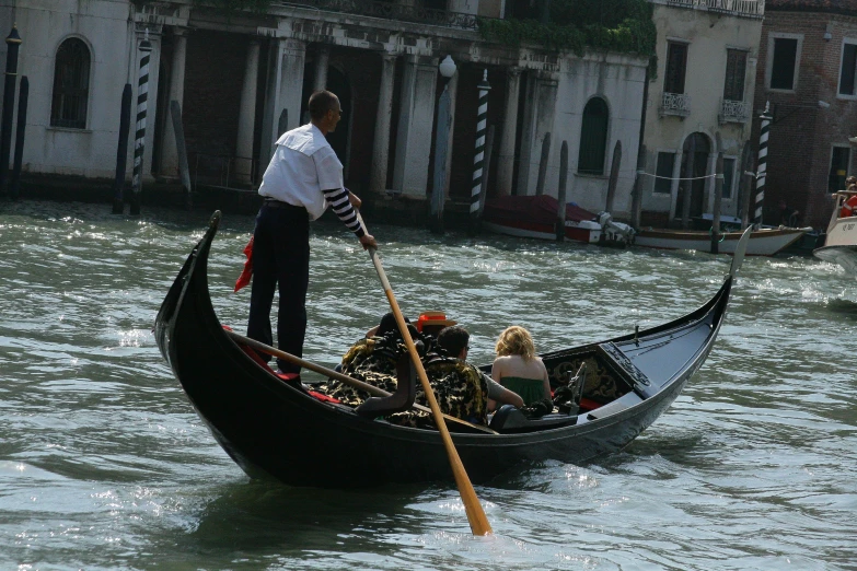 the man is on his gondola in the water