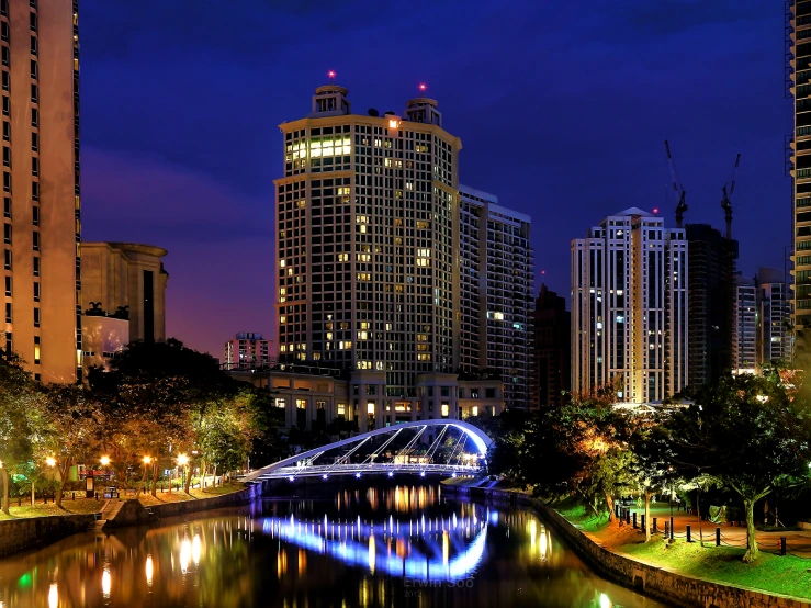 city skyline over a waterway in a river at night