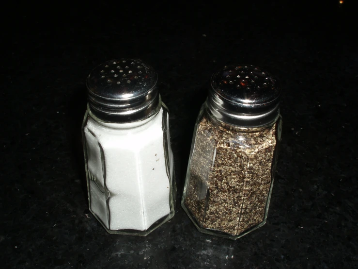 two jars are shown with spice sprinkled in them