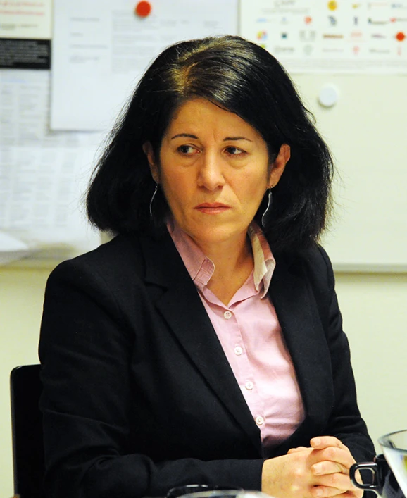 a woman in a business suit sitting at a desk