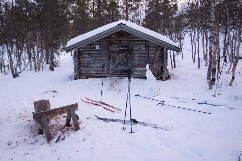 a snow covered area with small house in distance