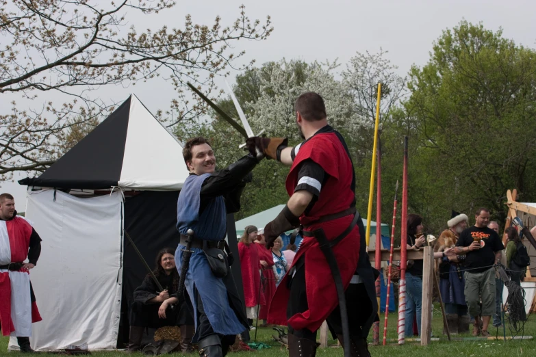 two men in medieval costumes holding swords