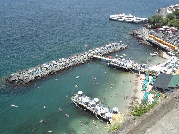 a marina on the ocean is crowded with people