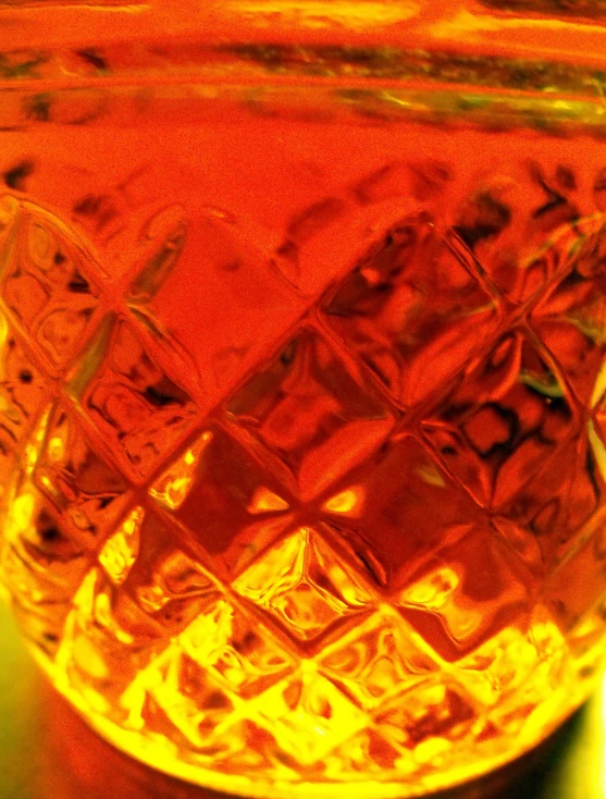 the bottom of an orange glass bottle filled with liquid