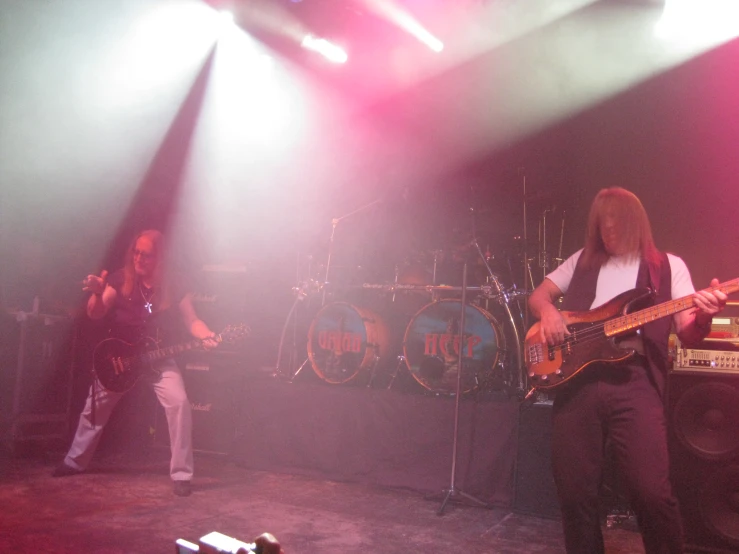 two men on stage with guitars and keyboards