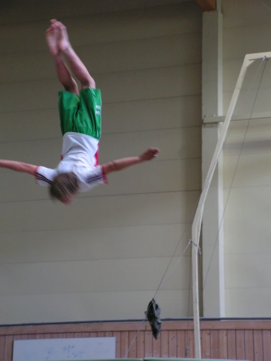 a man diving to grab on a soccer ball