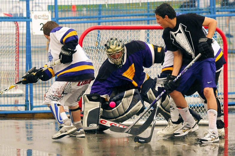 a group of young men playing ice hockey