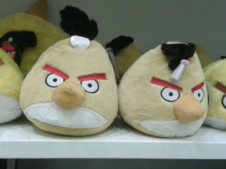 a shelf with several angry birds slippers on it