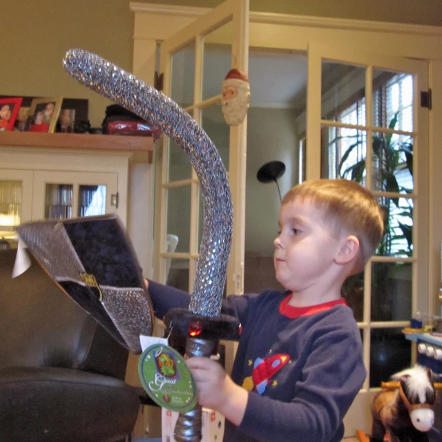 a  plays with a toy airplane in his living room