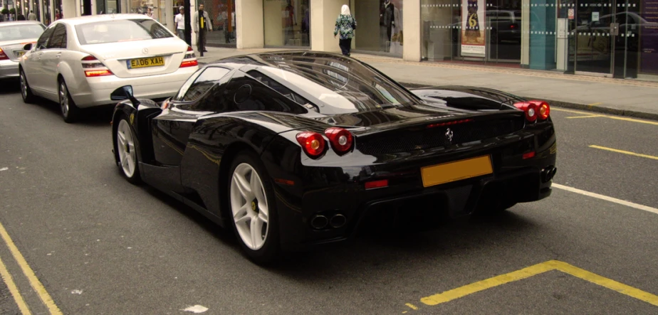 a black sports car is on the side of the street