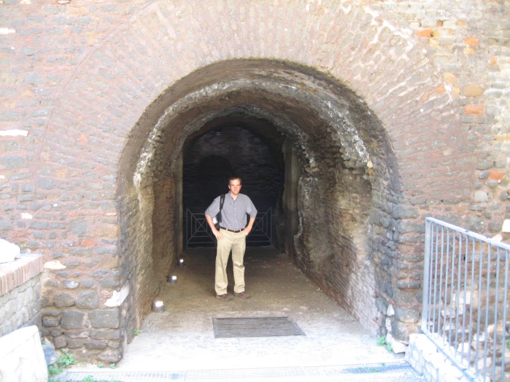 a man standing in a tunnel while staring at the camera