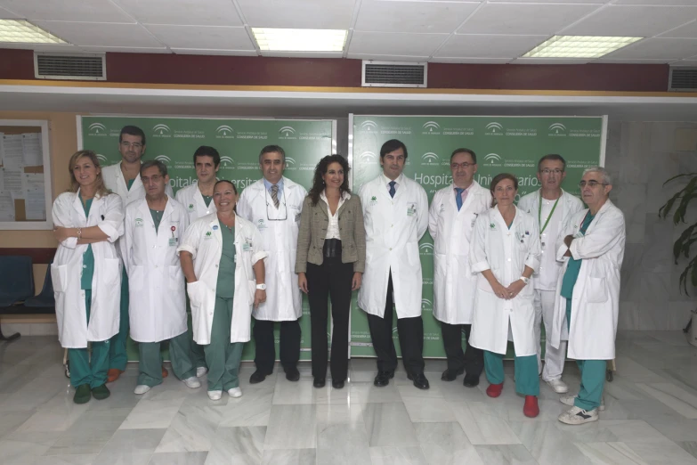 people are wearing white lab coats in front of a chalkboard