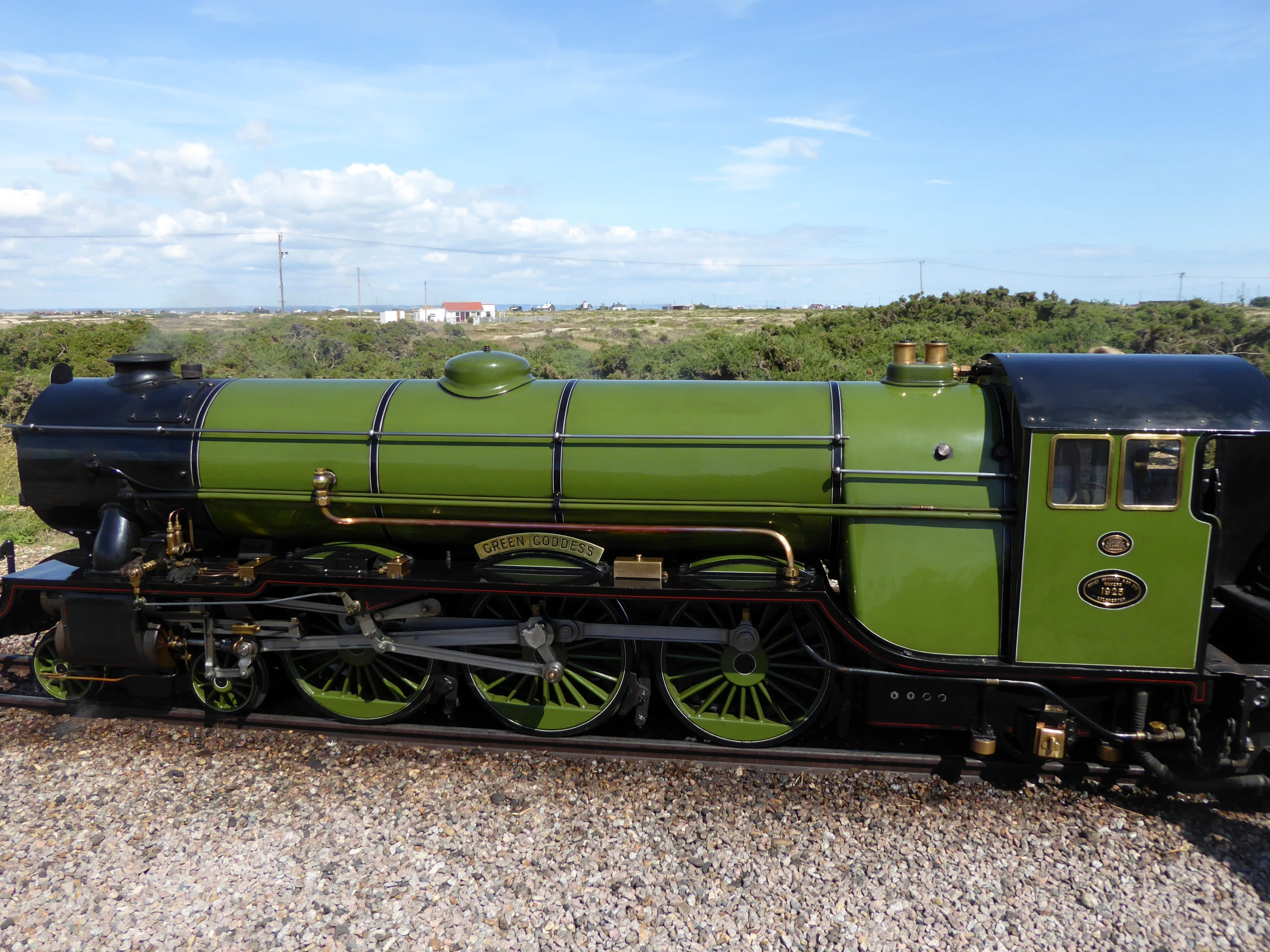 an antique steam train on display in the countryside