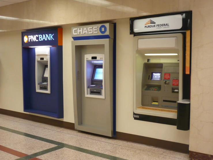 two atm machines next to each other in an airport