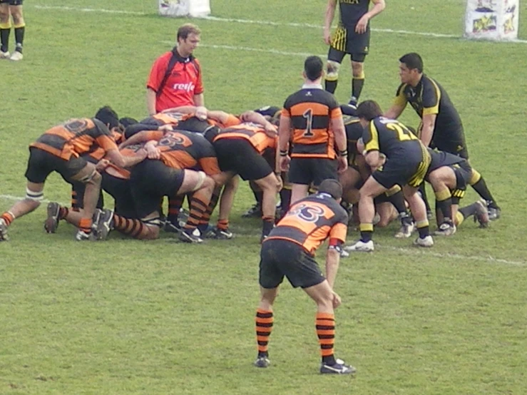 many football players are huddled around a referee on the field