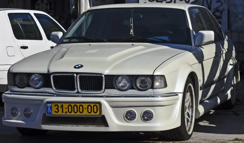 a white car parked next to another white one