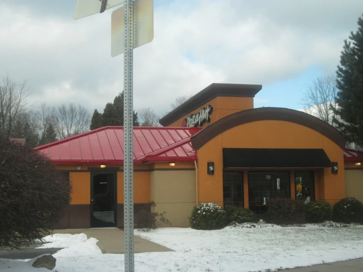 a building with a store and a red roof