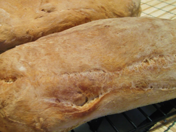 two large round pieces of bread sitting on top of a cooling rack