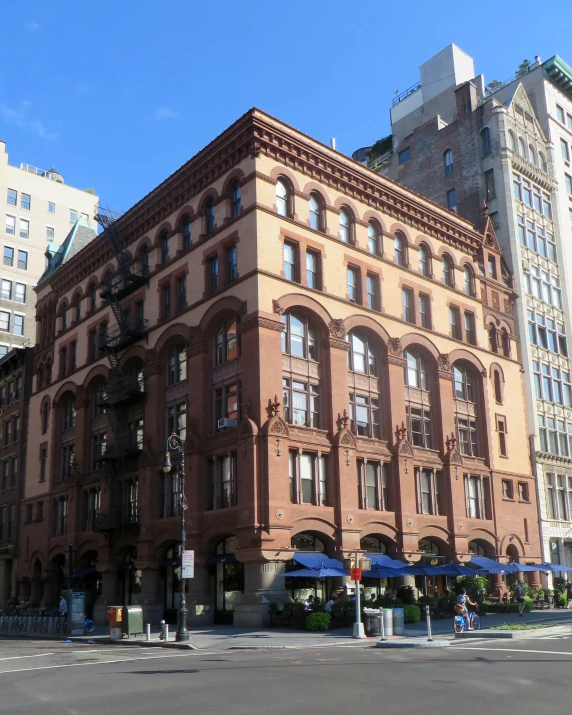 a large building with a group of tall buildings in the back