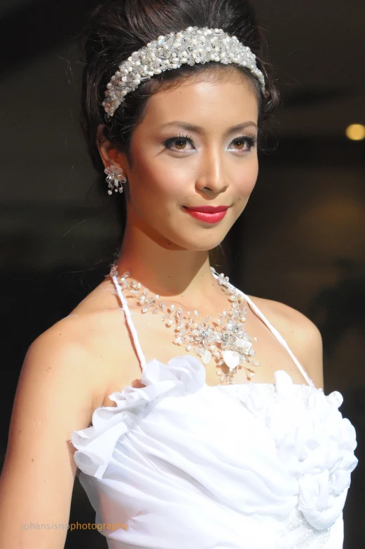 the beautiful asian bride has an elegant headpiece