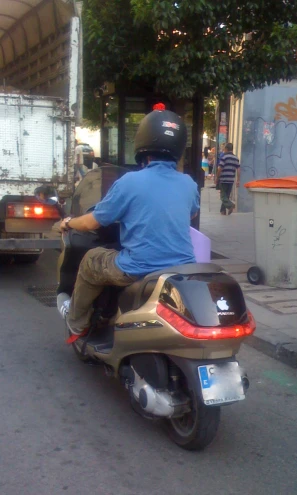 a man riding a motor bike down the road