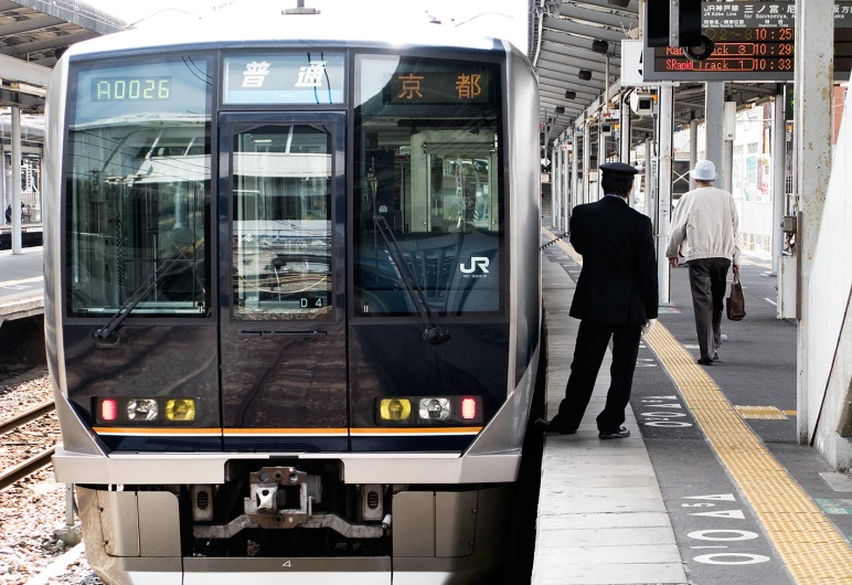 a black and white train is stopped on a railroad track