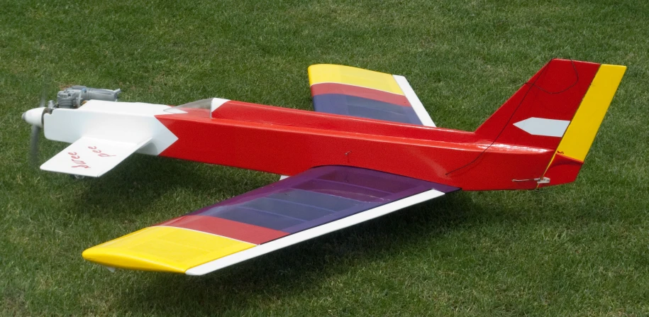 a small airplane sitting on a grass covered field