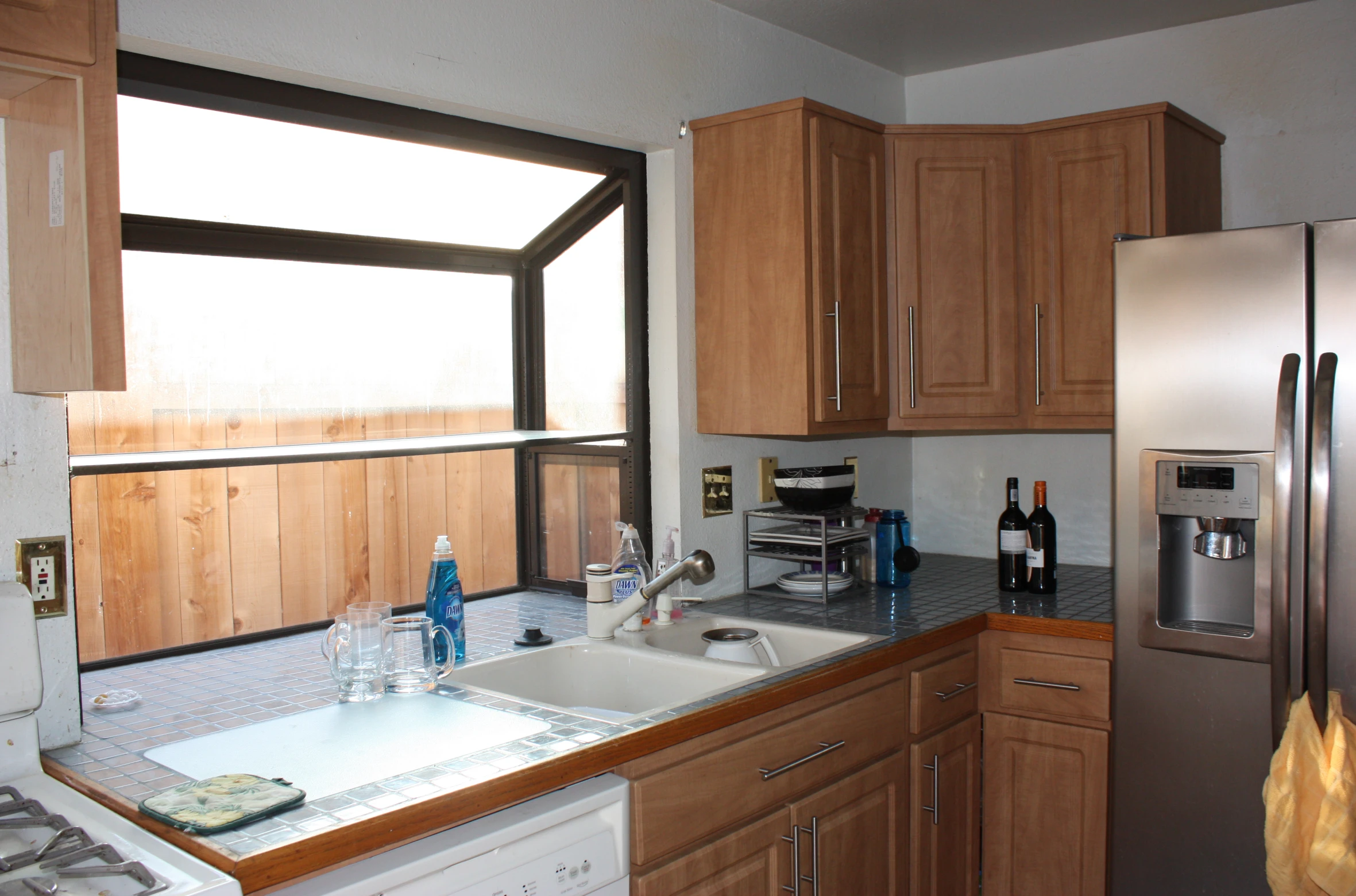 a kitchen with wooden cabinets and appliances