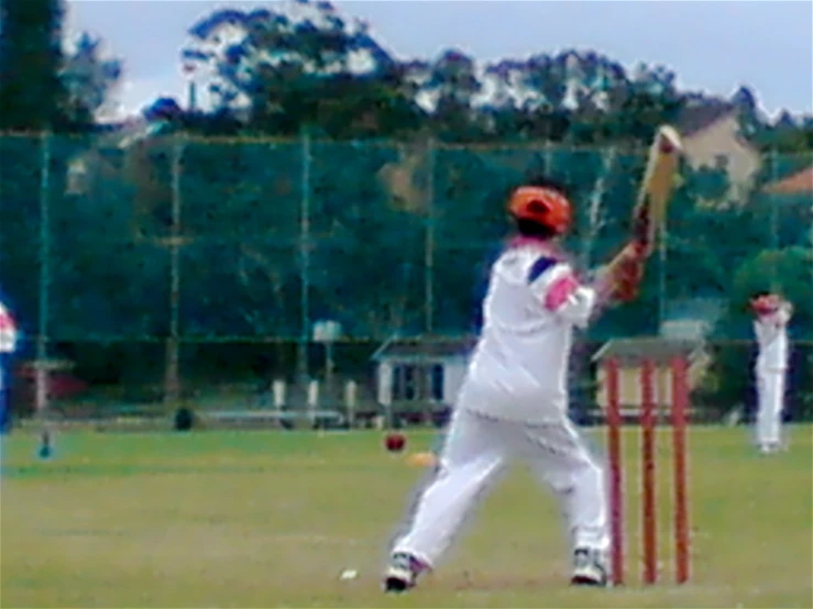 a baseball player hitting a baseball with a bat