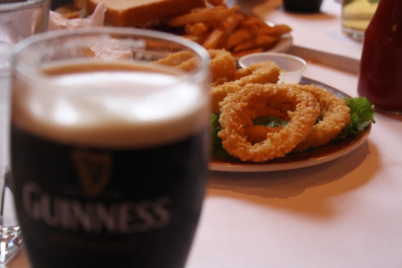 a beer and onion rings are sitting on the table