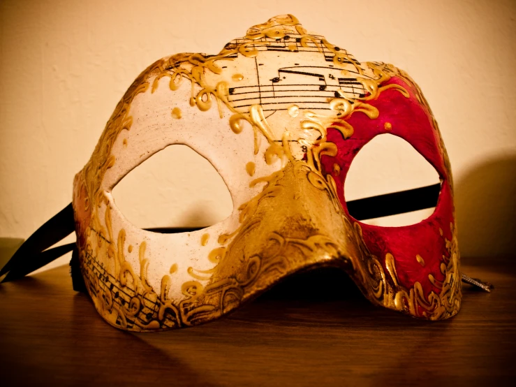 a masquerade mask with musical notes on it
