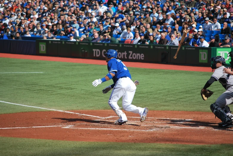 the baseball players are running for first base