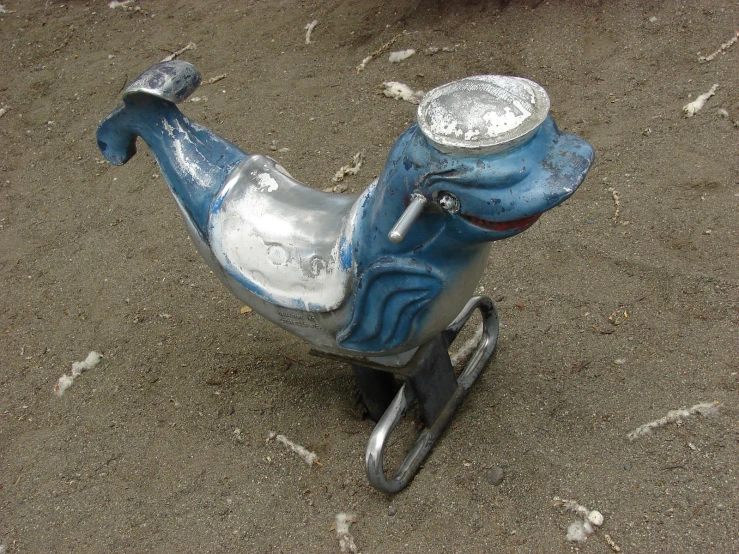 a small child's tricycle with a metal horse in the front