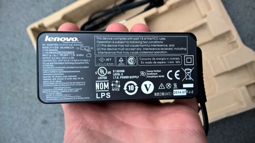 a person holding up a black and white battery