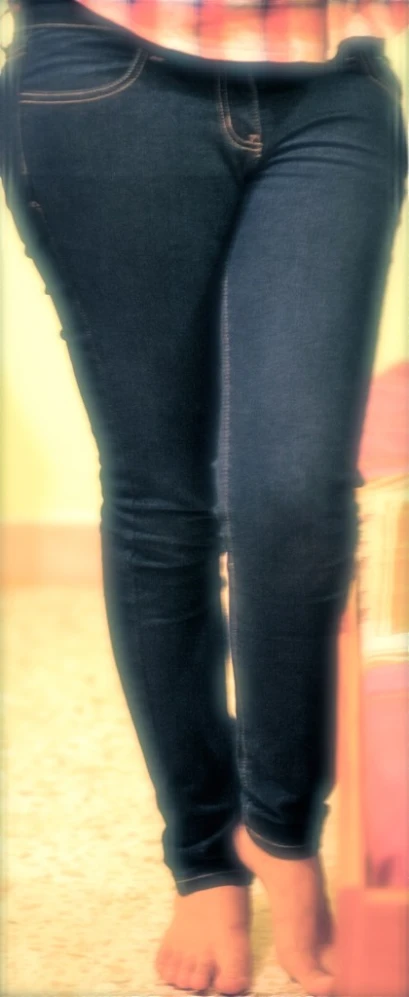 a woman standing up wearing very tight jeans