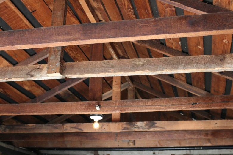 a ceiling made from a wood rafter that is brown