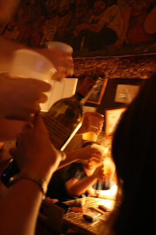 a group of people holding onto their beverages