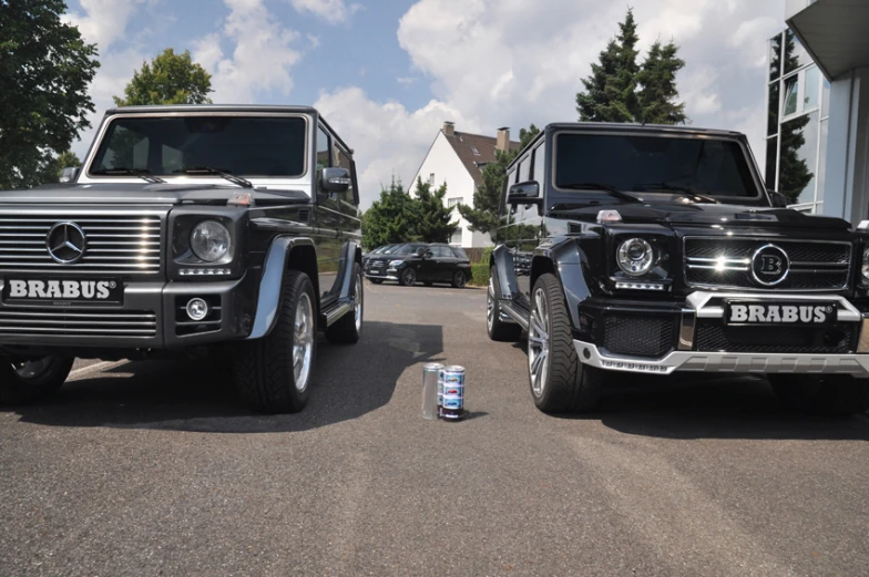 mercedes benzs and other vehicles parked outside of a building