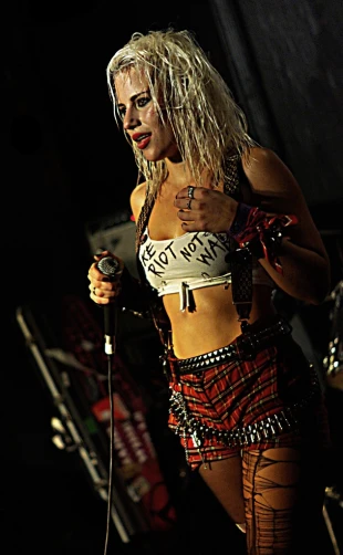 an attractive woman in a skirt and belt, holding a microphone