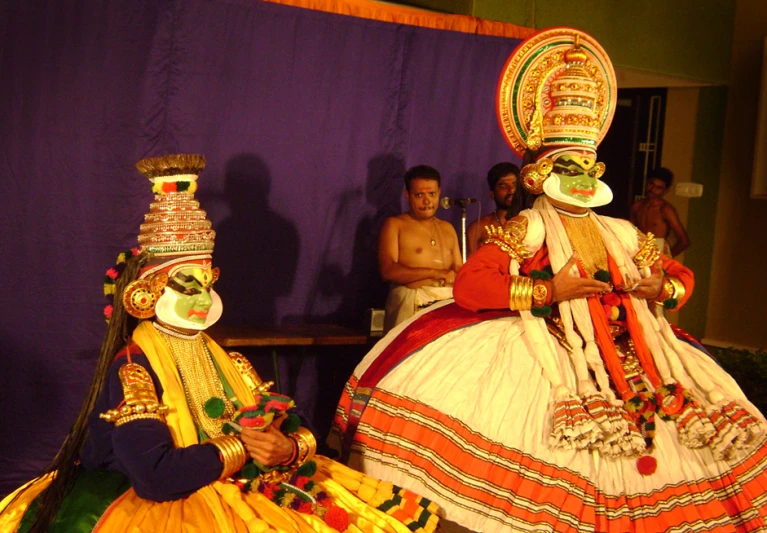 two men are dressed in costume with masks