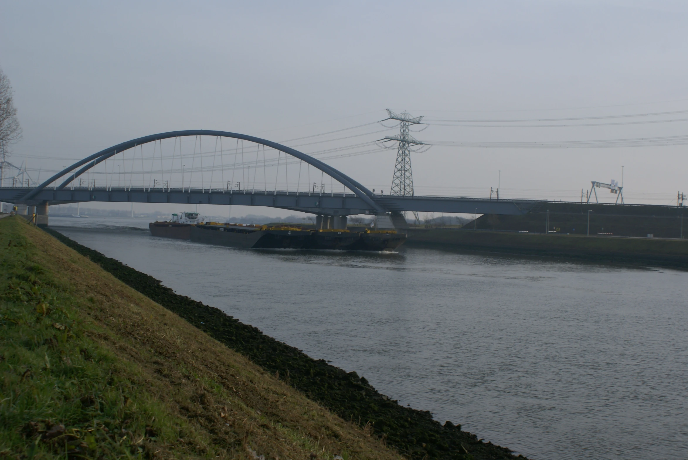 a large boat travels under a bridge in the water