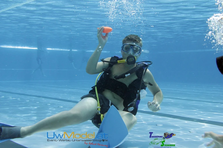 a woman is wearing a life jacket under water