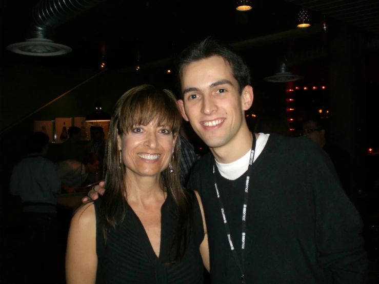 a young man and woman posing for a picture