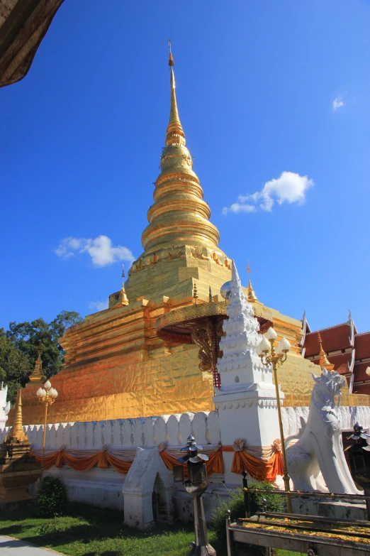 a gold pagoda in a lush green park